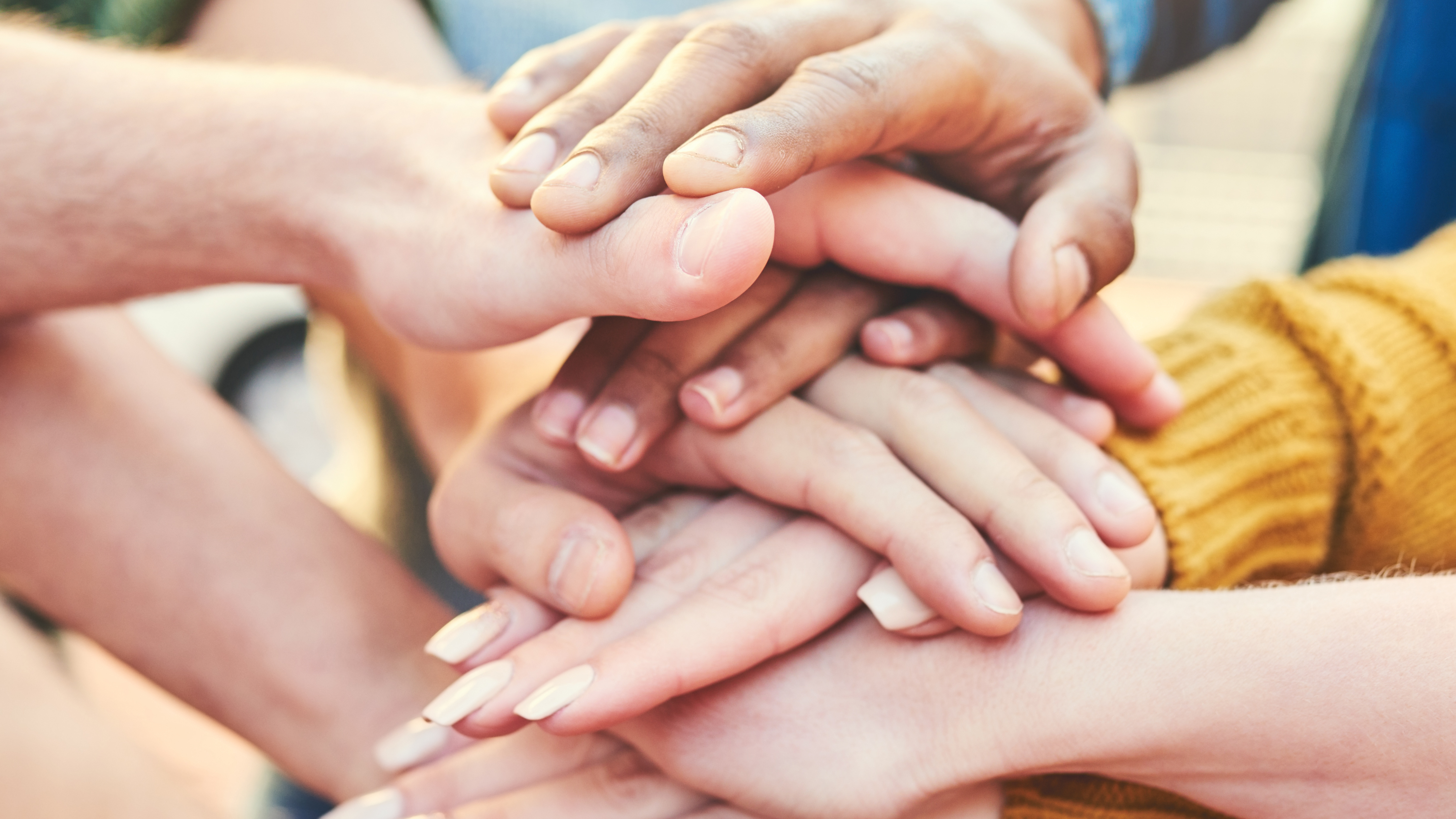 Group showing support to each other by having their hand on each others